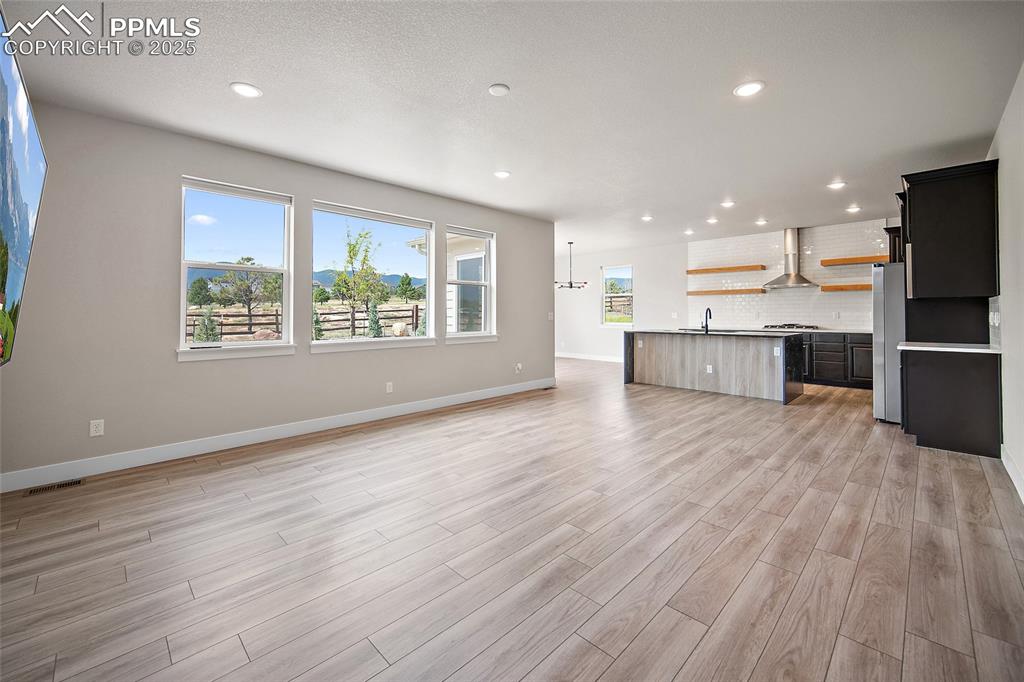 Image 21 of 46: Unfurnished living room with recessed lighting, light wood-type flooring, a
