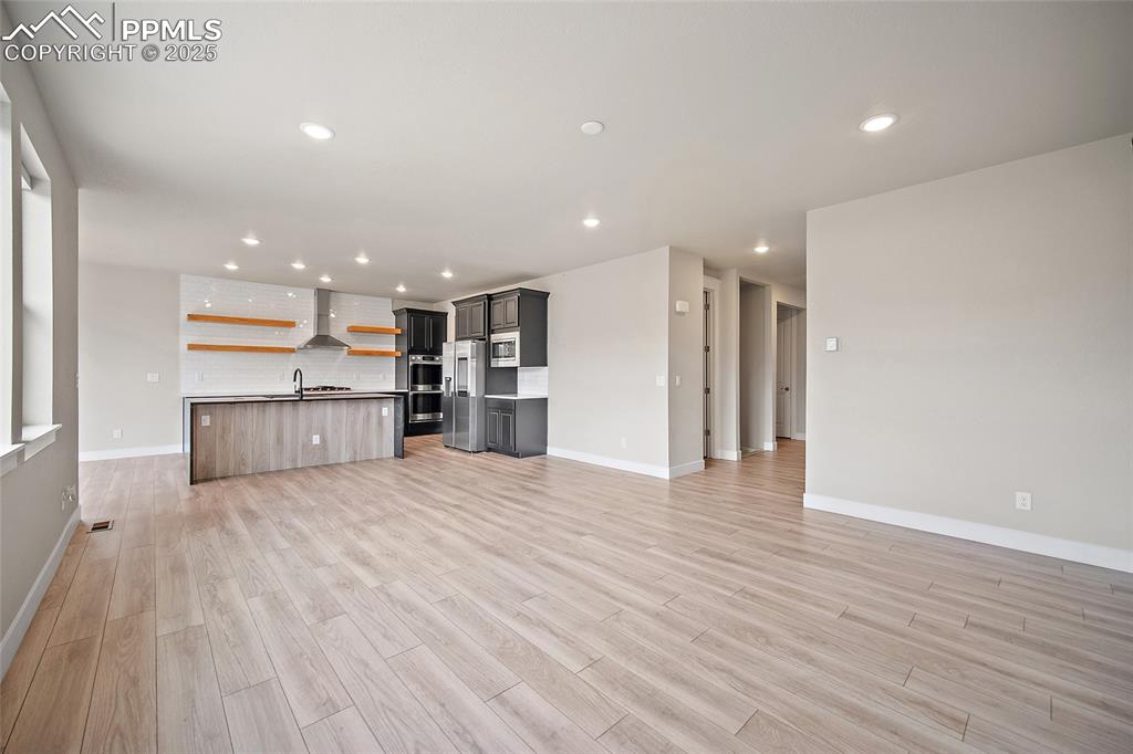 Image 22 of 46: Unfurnished living room featuring recessed lighting and light wood finished