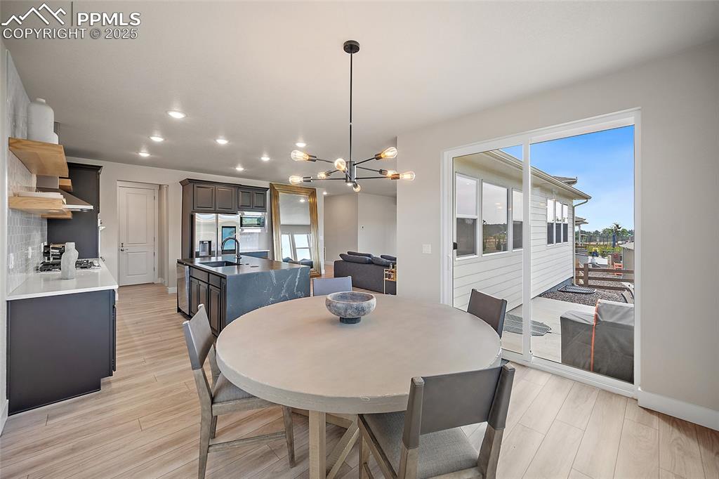Image 28 of 46: Dining space with a chandelier, light wood-type flooring, and recessed ligh