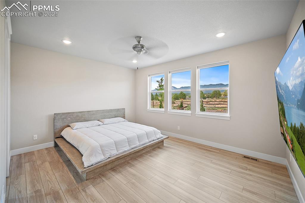 Image 29 of 46: Bedroom with a ceiling fan, light wood-style flooring, and recessed lightin