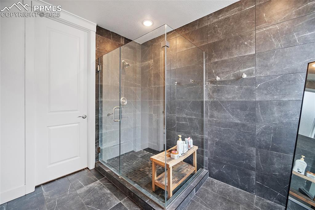 Image 31 of 46: Full bathroom featuring a shower stall and recessed lighting