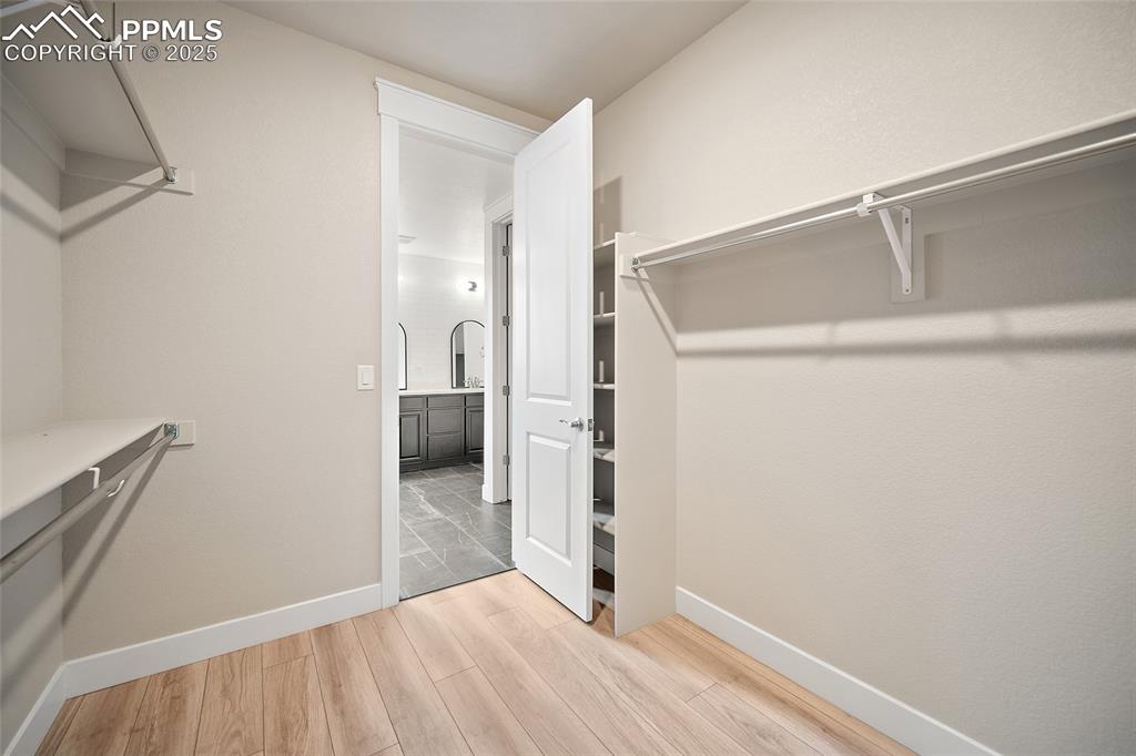 Image 34 of 46: Spacious closet with light wood-style flooring