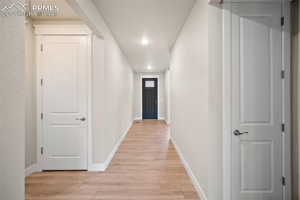 Image 35 of 46: Hallway with light wood finished floors and recessed lighting