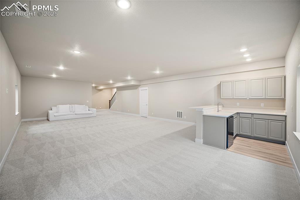 Image 38 of 46: Unfurnished living room with recessed lighting and light colored carpet