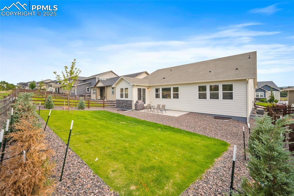 Image 44 of 46: Rear view of property with a patio, a shingled roof, and a residential view