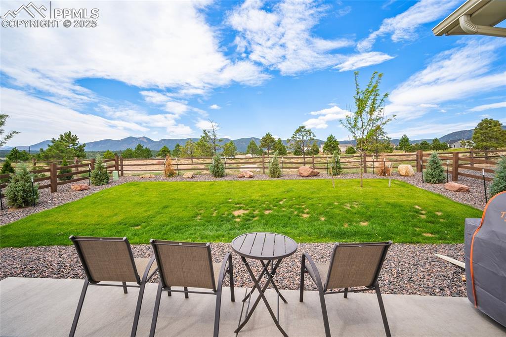 Image 46 of 46: Fenced backyard featuring a rural view, a patio, and a mountain view