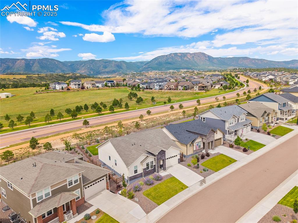 Image 5 of 46: Aerial perspective of suburban area with a mountain backdrop
