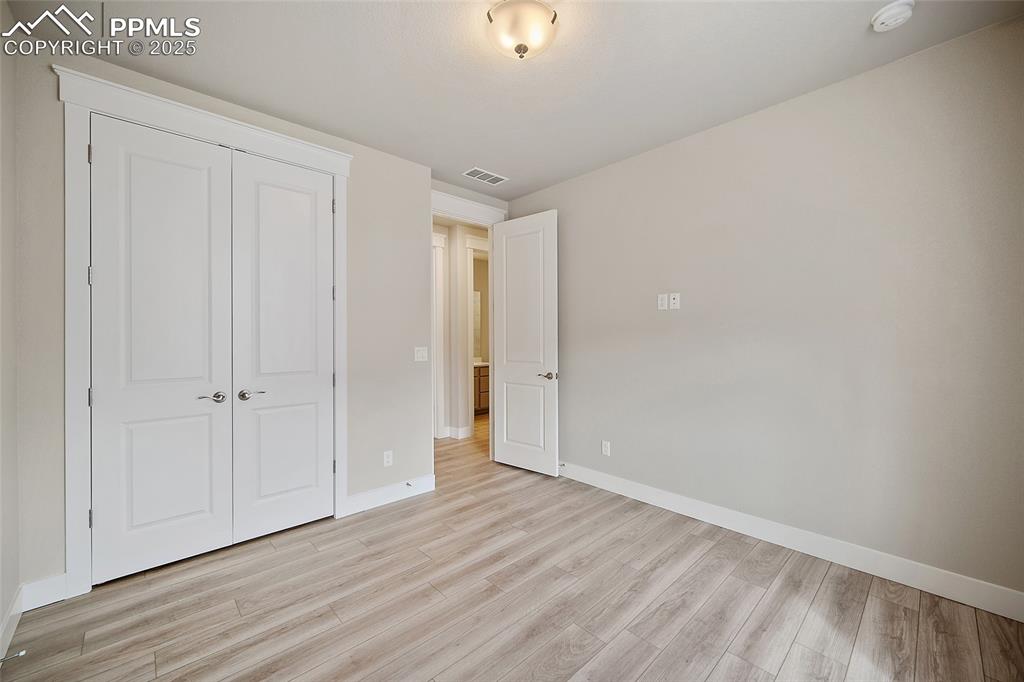 Image 8 of 46: Unfurnished bedroom featuring light wood-type flooring and a closet