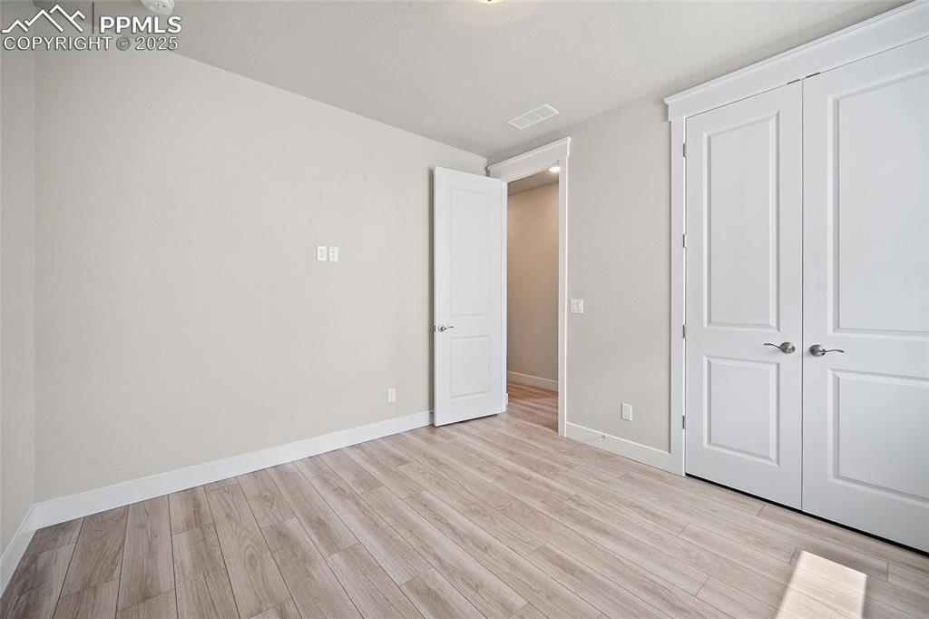 Image 9 of 46: Unfurnished bedroom featuring light wood-type flooring and a closet