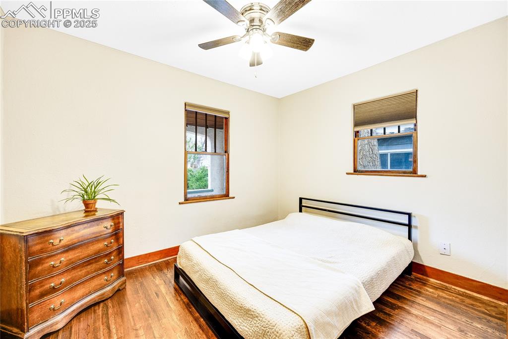 Image 10 of 34: Bedroom featuring baseboards, wood finished floors, and a ceiling fan