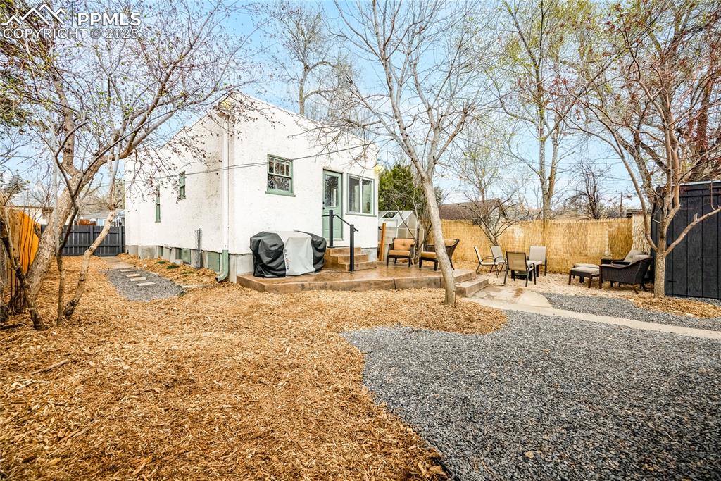 Image 19 of 34: View of main yard featuring a shed and patios