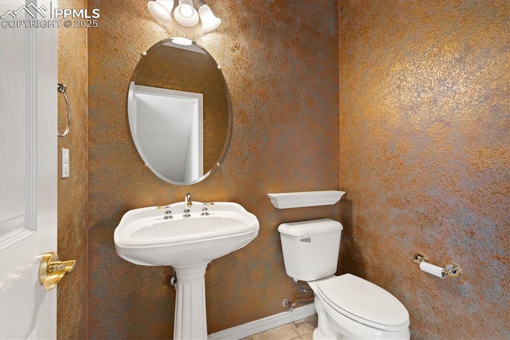 Image 12 of 33: Bathroom with toilet and tile patterned floors