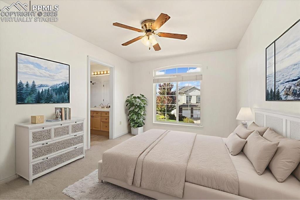 Image 19 of 33: Carpeted bedroom featuring ensuite bathroom and ceiling fan - Virtually Sta