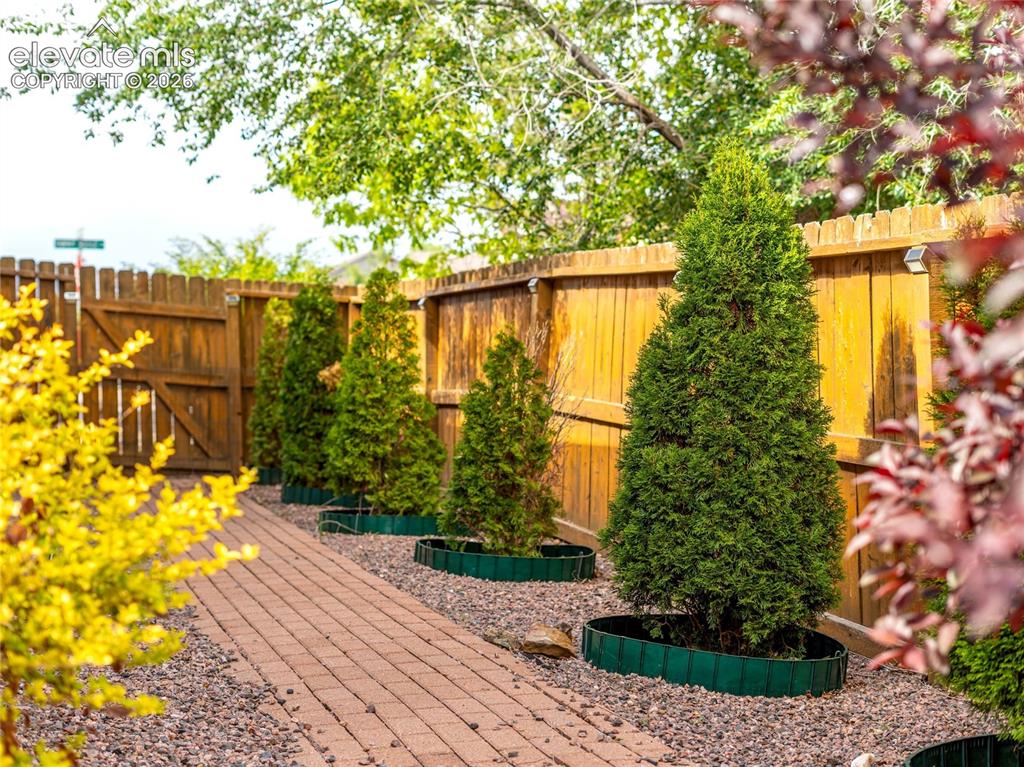 Image 27 of 29: The covered patio creates the perfect setting for morning coffee, outdoor d