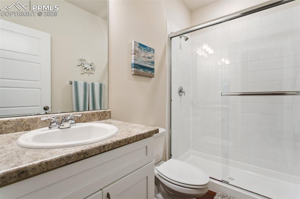 Image 31 of 41: Full bath with toilet, a stall shower, and vanity