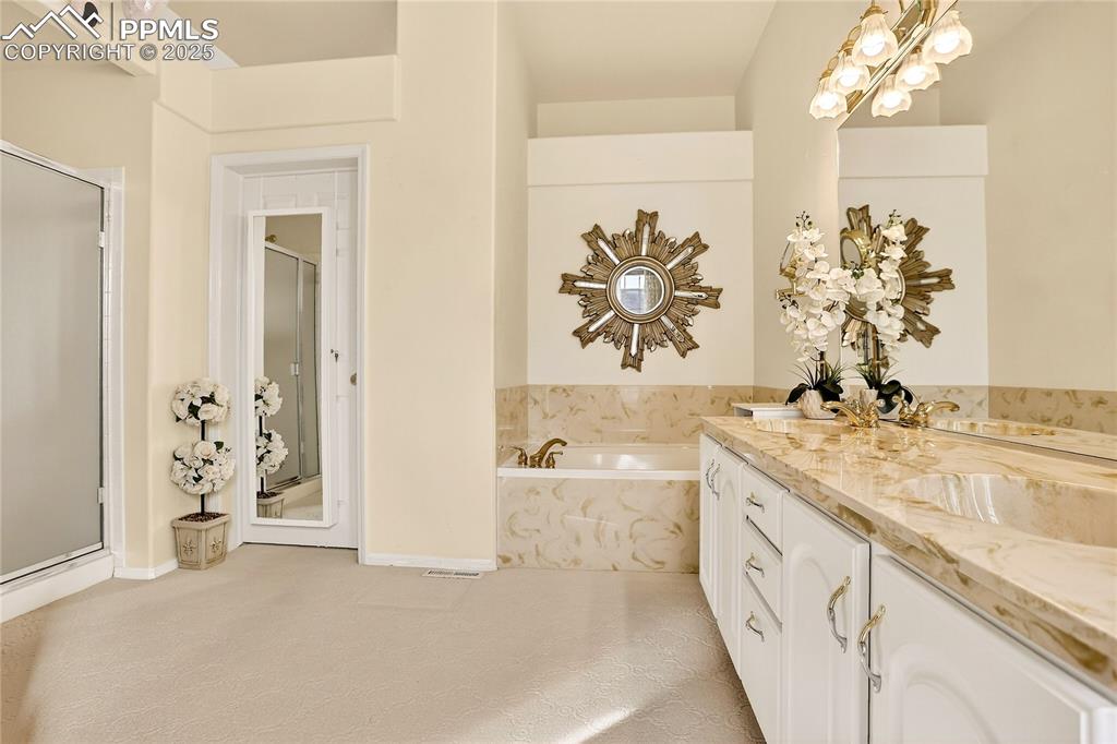 Image 13 of 21: 5-piece primary bath & walk-in closet