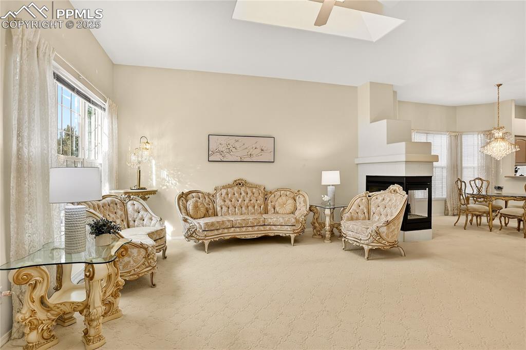 Image 5 of 21: Flowing floorplan w/ 3-sided fireplace