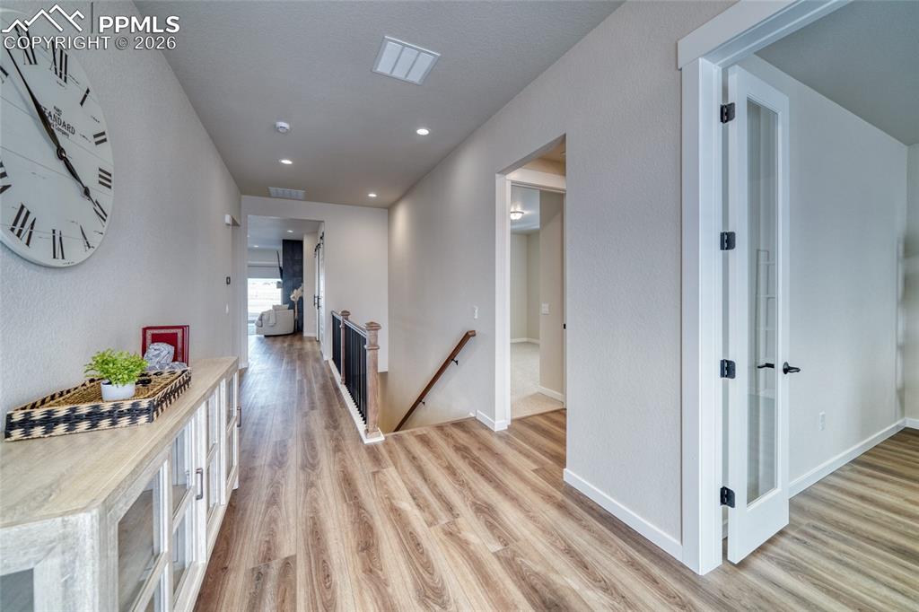 Image 10 of 50: Corridor featuring an upstairs landing, light wood finished floors, and rec