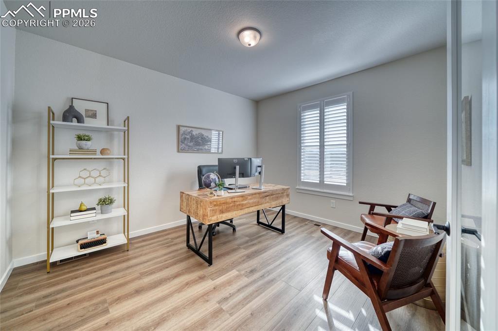 Image 11 of 50: Office space with baseboards and light wood-style flooring