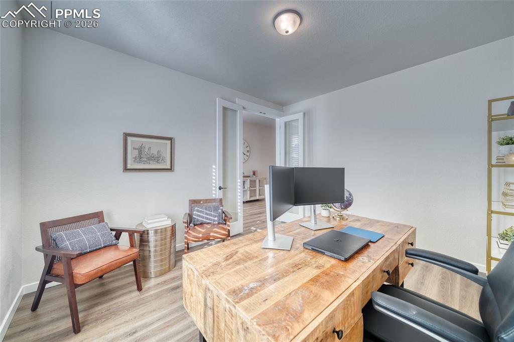 Image 12 of 50: Office featuring light wood-style floors