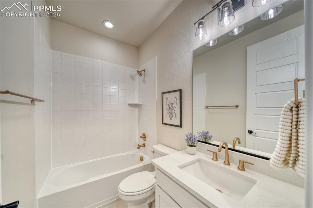 Image 41 of 50: Bathroom with vanity, shower / washtub combination, a textured wall, and re