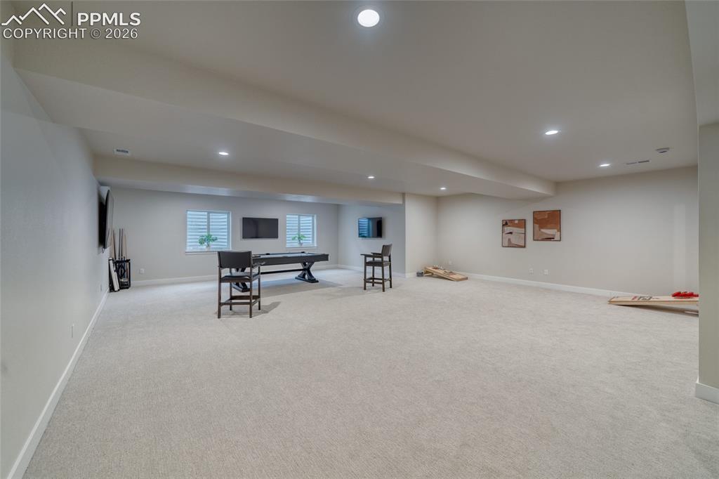 Image 44 of 50: Rec room with light carpet and recessed lighting