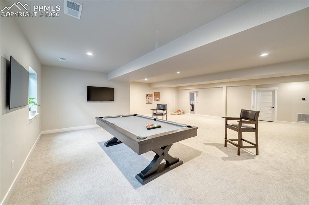 Image 45 of 50: Recreation room with billiards, light carpet, and recessed lighting