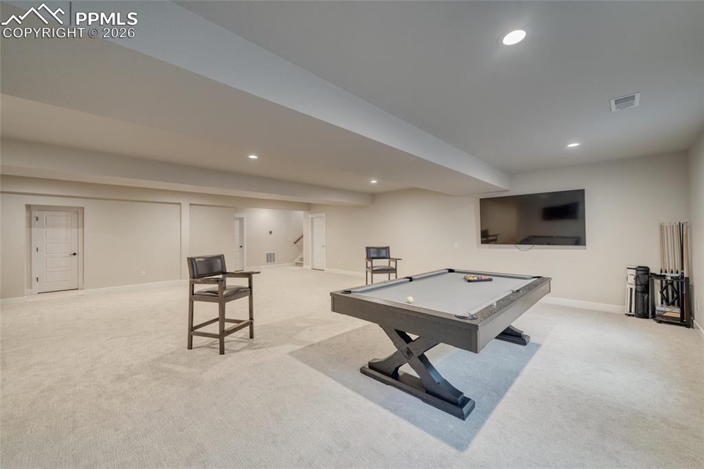 Image 46 of 50: Recreation room featuring billiards, light carpet, and recessed lighting