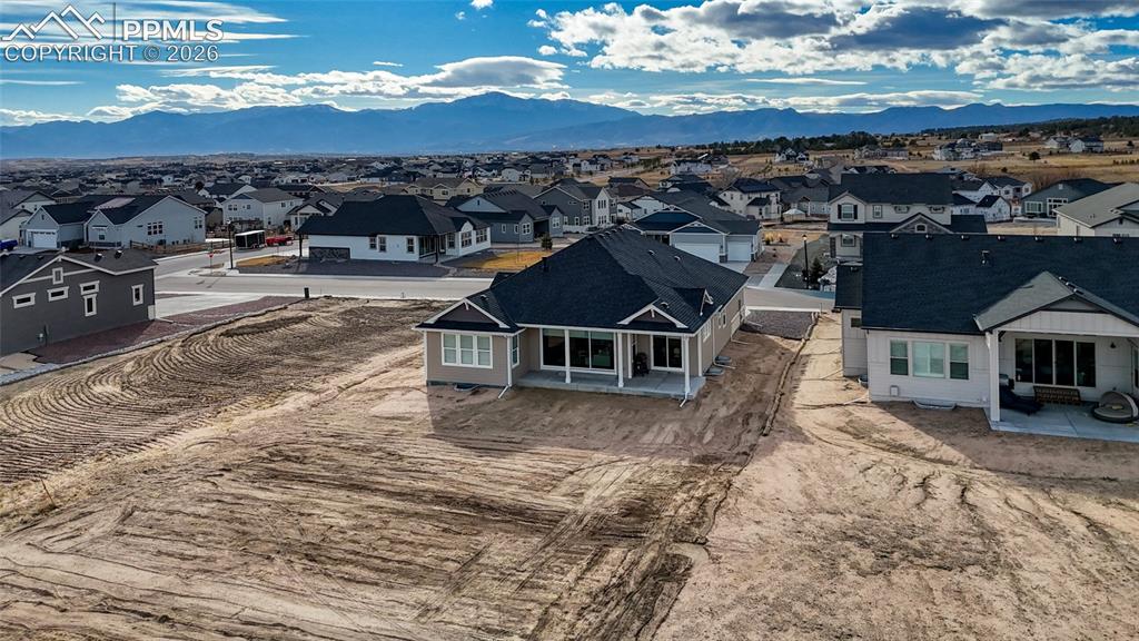 Image 5 of 50: Aerial perspective of suburban area with a mountain backdrop