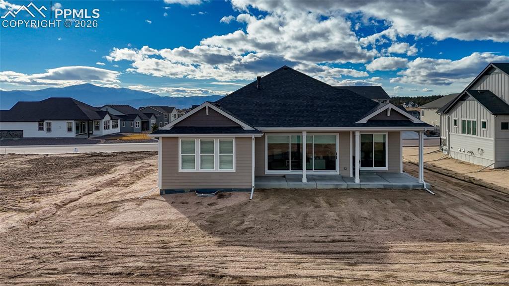 Image 6 of 50: Back of property featuring a patio and a residential view