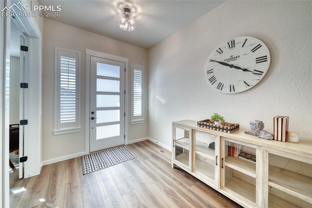 Image 9 of 50: Entryway with light wood-type flooring and a textured wall