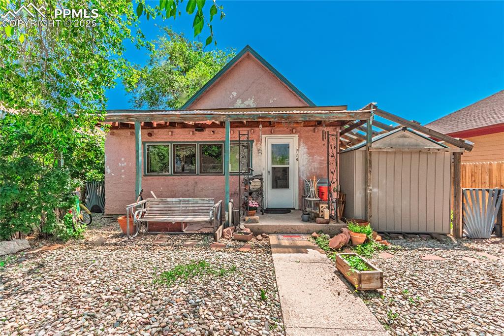 Caption: View of front of house and stucco siding