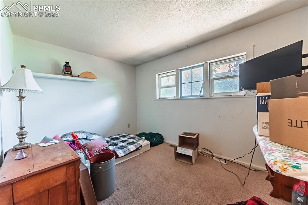 Image 12 of 22: Front Unit, Carpeted bedroom