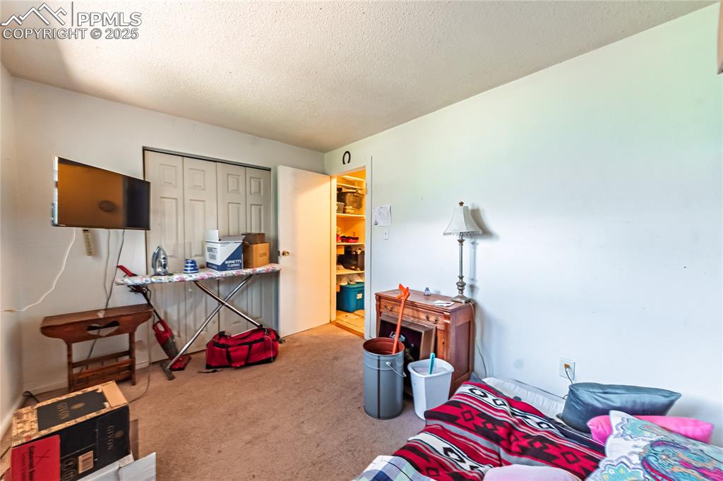 Image 13 of 22: Front Unit, Carpeted bedroom