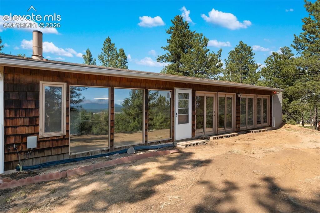Image 1 of 46: Exterior featuring shake siding, a row of large windows, a single entry doo