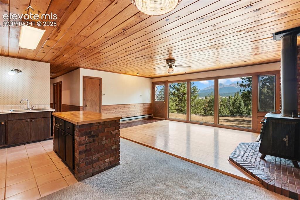 Image 17 of 46: Expansive window wall with mountain and tree scenery