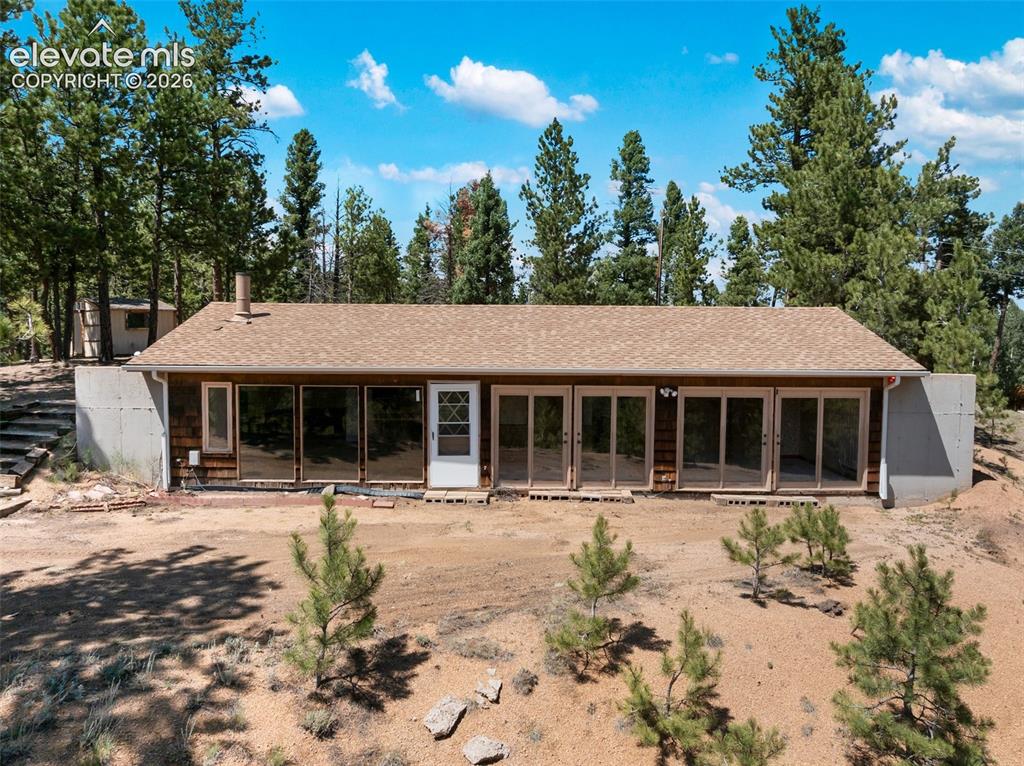 Image 46 of 46: Rustic cabin exterior featuring a brown shingle roof, wood siding, and mult
