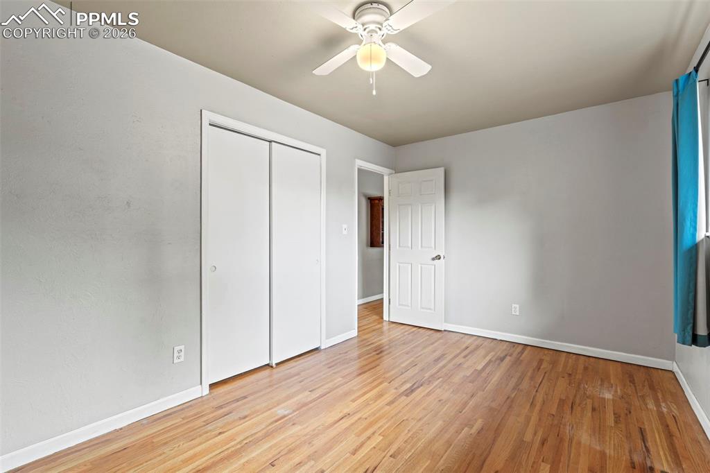 Image 14 of 28: Unfurnished bedroom with light wood-style flooring, a closet, and ceiling f