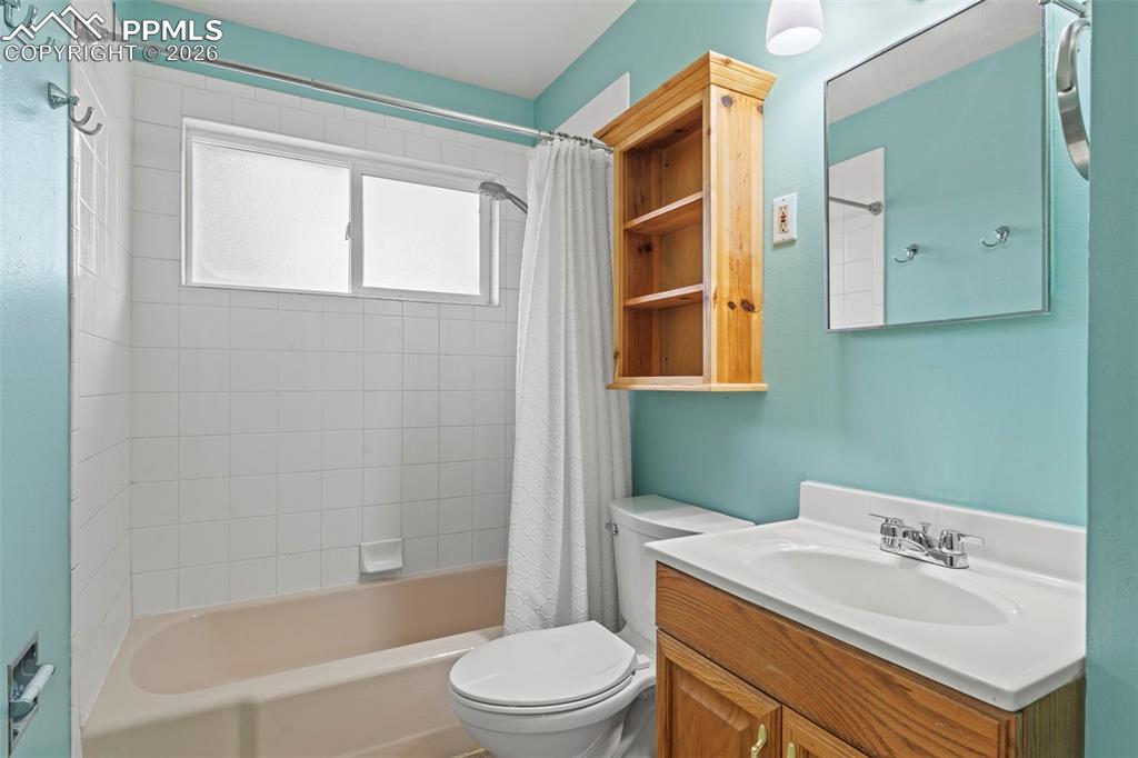 Image 15 of 28: Bathroom with vanity and shower / bathtub combination with curtain