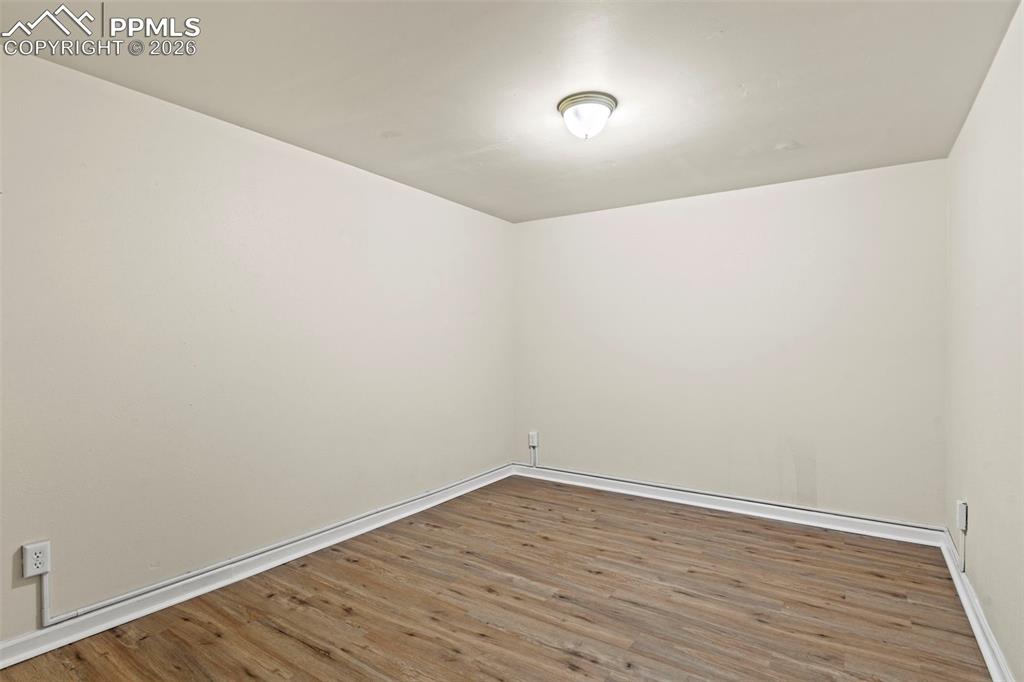 Image 21 of 28: Spare room with wood finished floors and baseboards