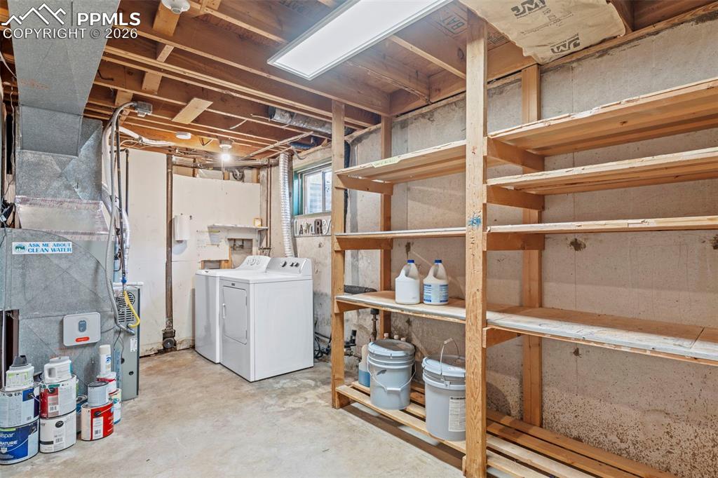 Image 26 of 28: Below grade area with separate washer and dryer and heating unit