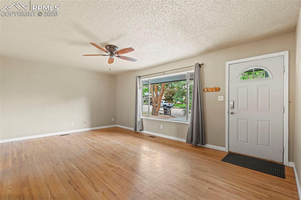 Image 6 of 28: Foyer featuring light wood-style flooring, a textured ceiling, and a ceilin