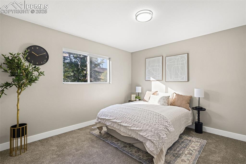 Image 6 of 15: Carpeted bedroom with baseboards