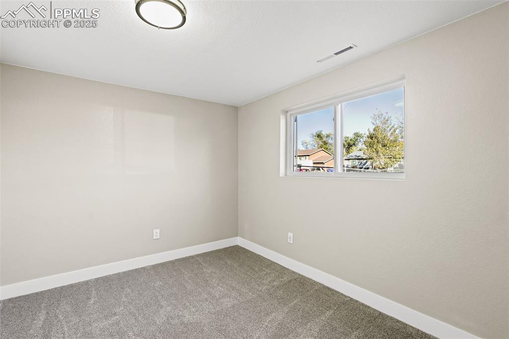 Image 9 of 15: Unfurnished room featuring baseboards and carpet