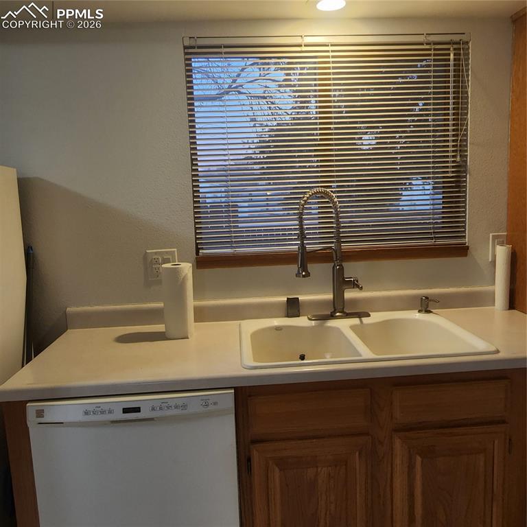 Image 10 of 23: refrigerator, dishwaher, and window that overlooks courtyard
