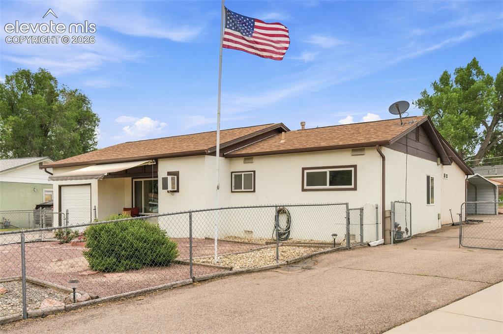 Image 1 of 38: Single-story residence featuring a neutral stucco exterior, brown trim, and