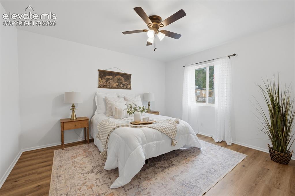 Image 14 of 38: Bedroom featuring wood-finish flooring, a ceiling fan with integrated light