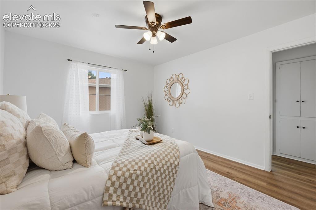 Image 15 of 38: Bedroom featuring a ceiling fan with integrated lighting, wood-finish floor