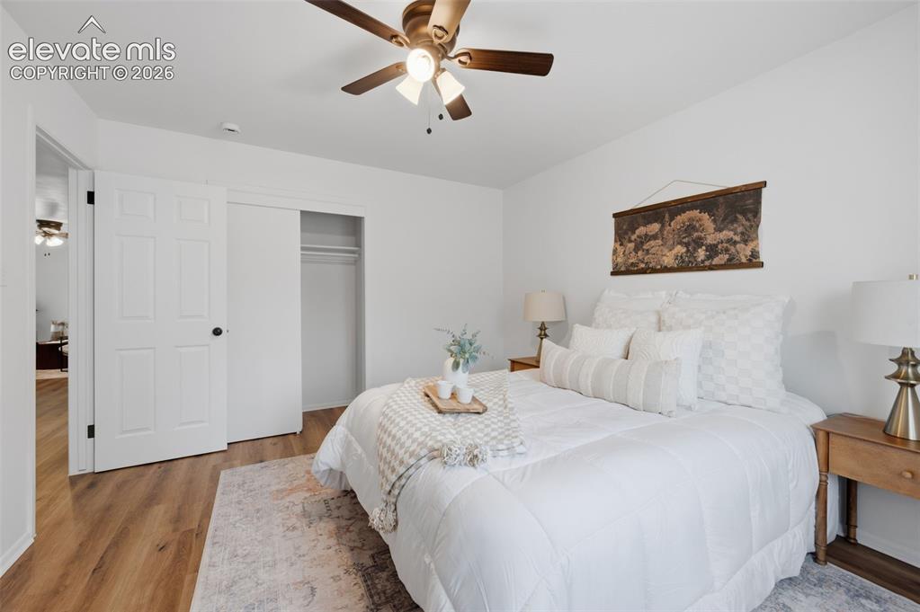 Image 16 of 38: Room featuring wood-finish flooring, crisp white walls, and a white-framed
