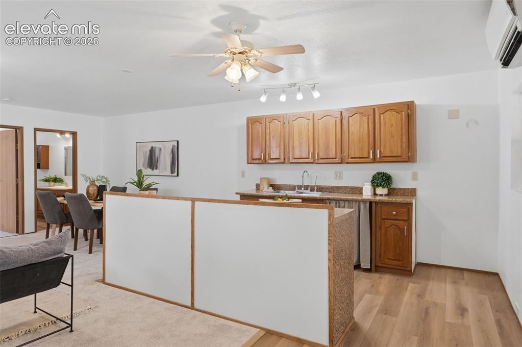 Image 24 of 38: Living area featuring three large windows, a sliding glass door, white wall